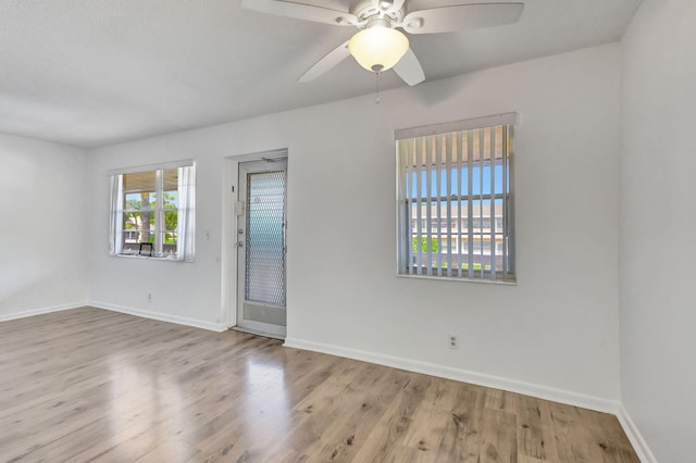 spare room featuring light wood-type flooring and ceiling fan