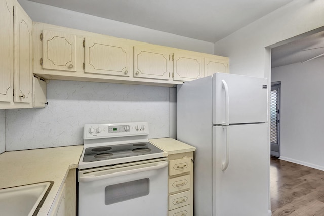 kitchen with light hardwood / wood-style floors, white appliances, and sink