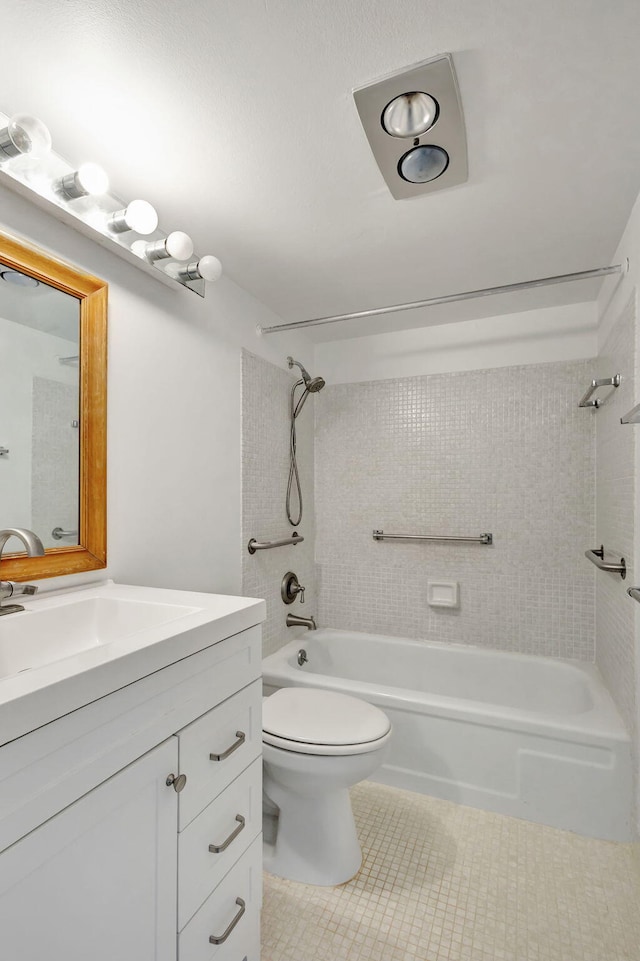 full bathroom featuring tile patterned flooring, vanity, toilet, and tiled shower / bath