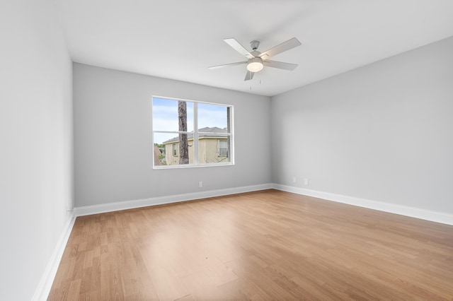 spare room featuring ceiling fan and light wood-type flooring