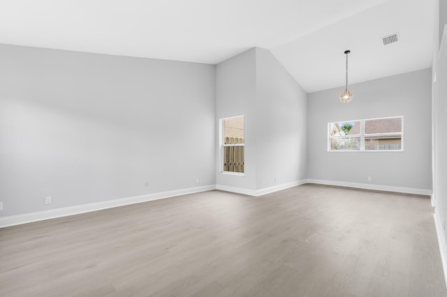 unfurnished room featuring light hardwood / wood-style flooring and vaulted ceiling