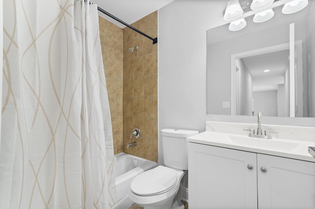 full bathroom with vanity, shower / bath combination with curtain, and toilet