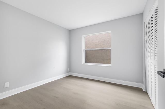 unfurnished bedroom with light hardwood / wood-style floors and a closet