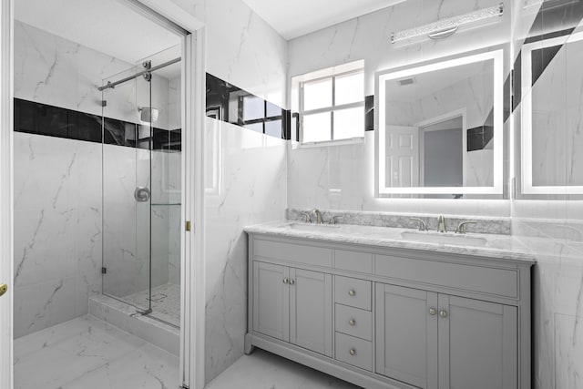 bathroom with vanity and a shower with door