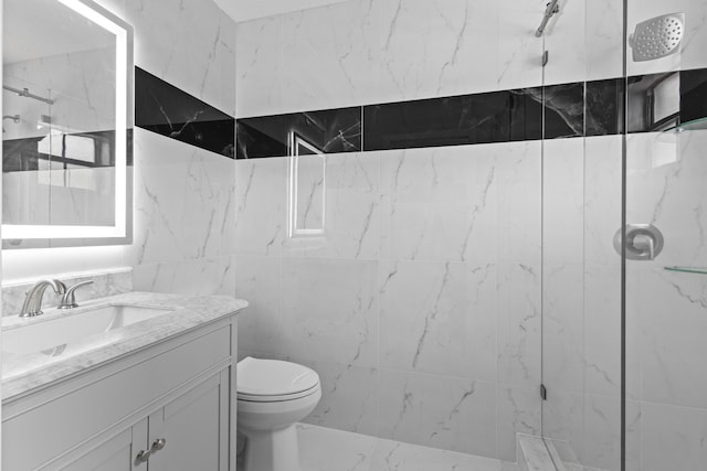 bathroom with vanity, toilet, a shower, and tile walls