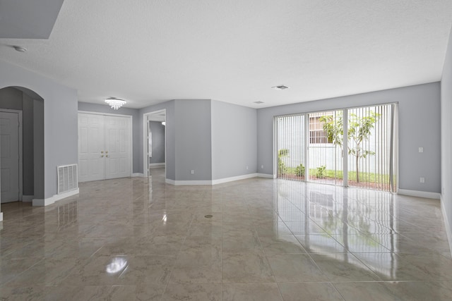 empty room with a textured ceiling