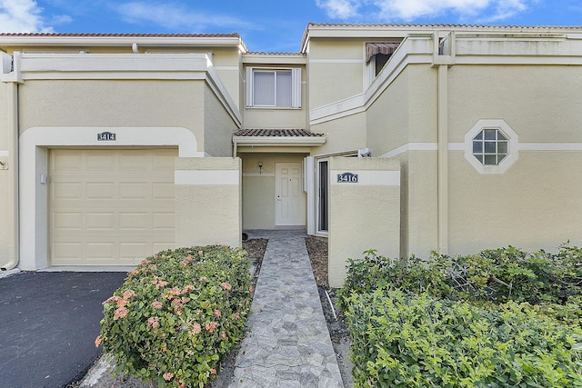 view of exterior entry featuring a garage