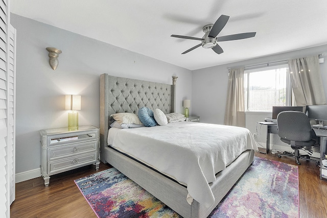 bedroom with dark hardwood / wood-style flooring and ceiling fan