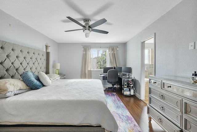 bedroom with a textured ceiling, ceiling fan, dark hardwood / wood-style floors, and ensuite bathroom