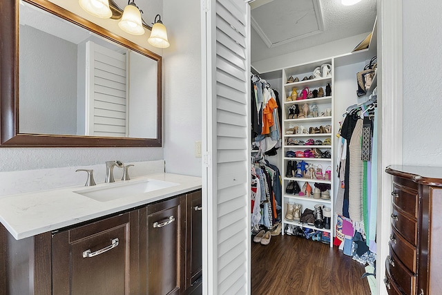 bathroom with vanity, hardwood / wood-style floors, and a textured ceiling