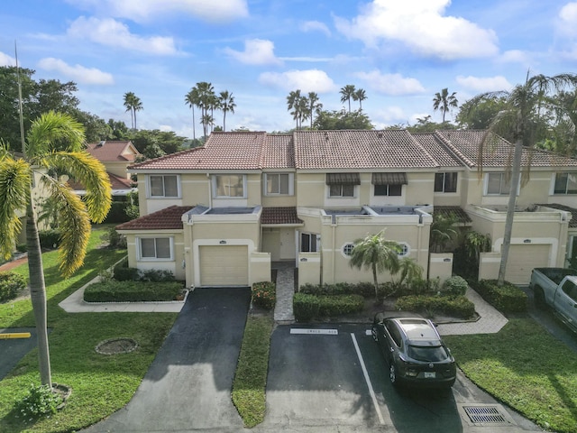 view of front facade with a front yard and a garage