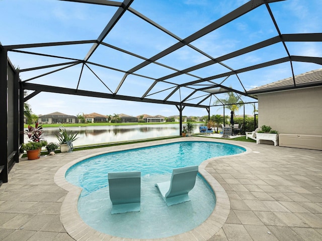 view of swimming pool featuring glass enclosure, a water view, and a patio