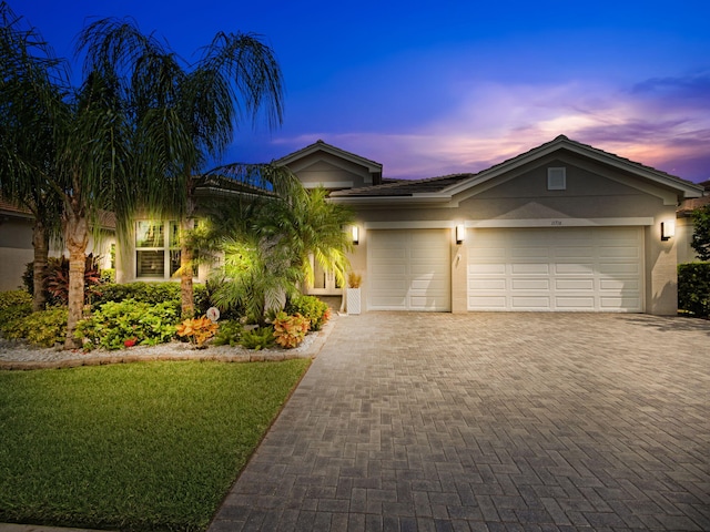 view of front facade featuring a lawn and a garage