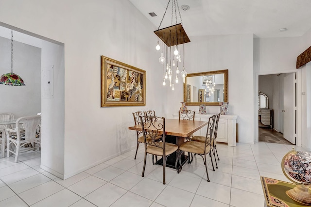 tiled dining room with a high ceiling