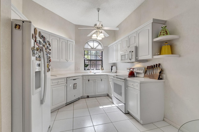 kitchen with white cabinets, a textured ceiling, white appliances, and ceiling fan