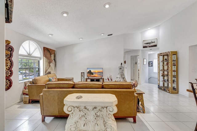 living room featuring light tile patterned floors and a textured ceiling