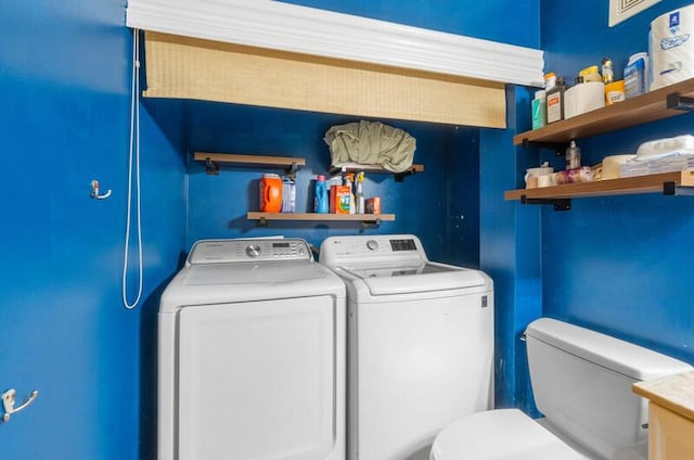 clothes washing area featuring separate washer and dryer