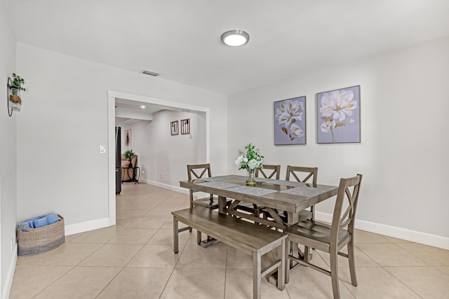 dining space with light tile patterned floors