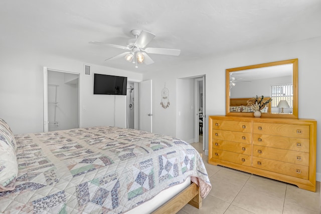 tiled bedroom featuring ceiling fan and a closet