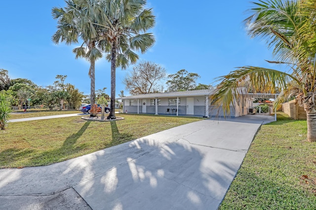 view of front of home with a front yard and a carport