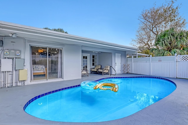 view of pool with ceiling fan and a patio area