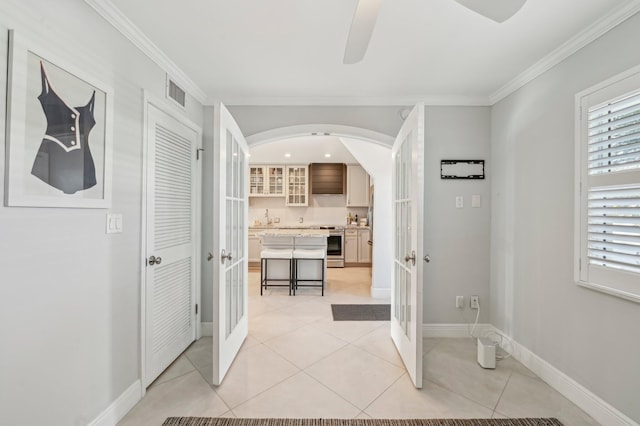 bathroom featuring tile patterned flooring, french doors, ceiling fan, and crown molding