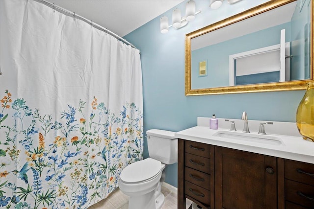 bathroom featuring tile patterned flooring, vanity, and toilet