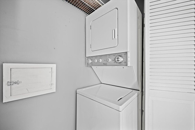 washroom featuring stacked washer and clothes dryer