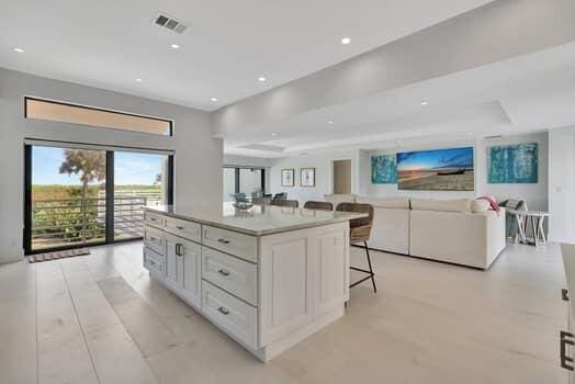 kitchen featuring white cabinets, a breakfast bar, and a center island