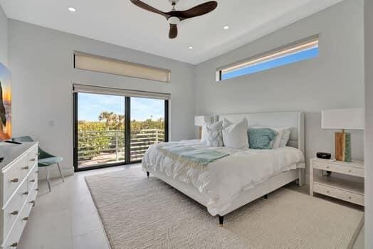 bedroom featuring ceiling fan and access to exterior