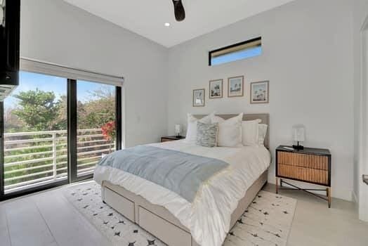 bedroom featuring ceiling fan and multiple windows