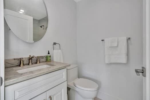 bathroom featuring toilet and vanity