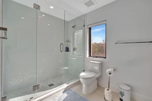 bathroom featuring toilet and walk in shower