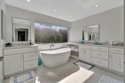 bathroom with vanity and a washtub