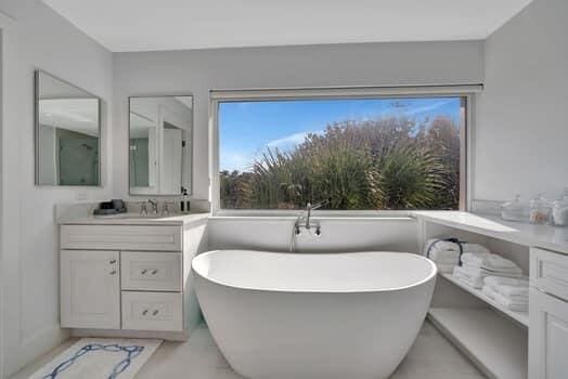 bathroom with vanity and a tub