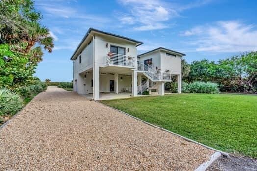 rear view of house with a lawn