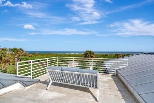 view of patio / terrace featuring a water view, outdoor lounge area, and a balcony