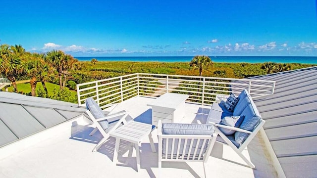 view of patio / terrace featuring a balcony and a water view