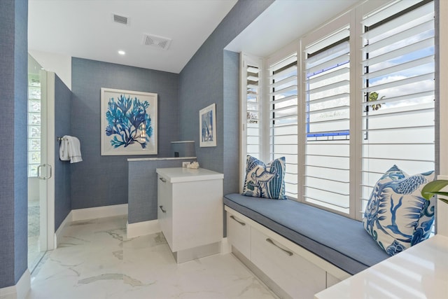 bathroom featuring marble finish floor, visible vents, baseboards, and wallpapered walls