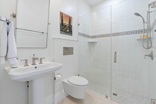 bathroom featuring toilet, a shower stall, and tile patterned flooring