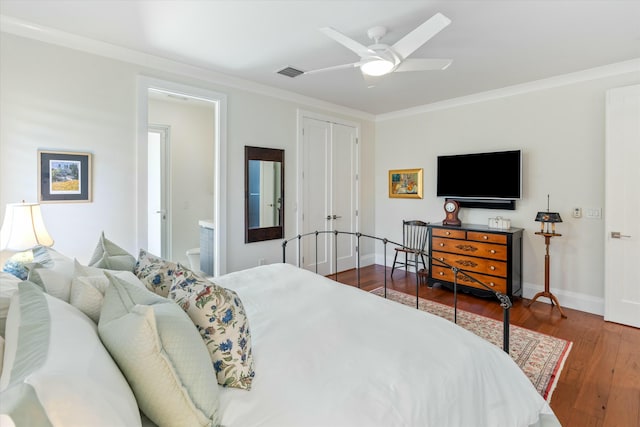 bedroom with visible vents, ornamental molding, ensuite bath, wood finished floors, and baseboards