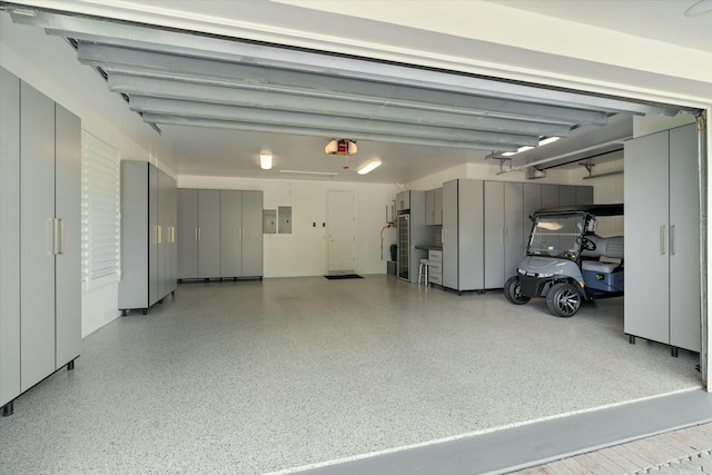 garage with electric panel and a garage door opener