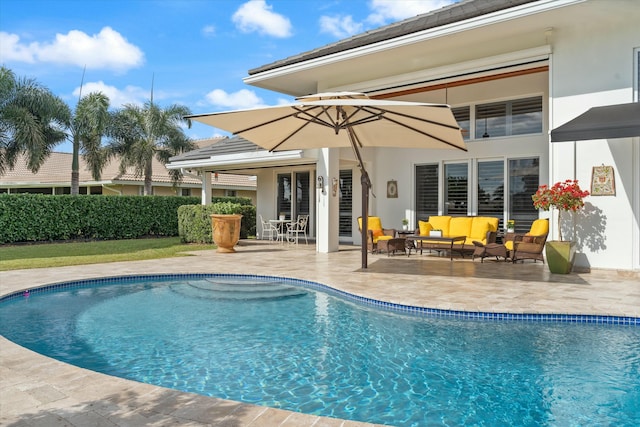 view of pool featuring a patio area, an outdoor living space, and a fenced in pool