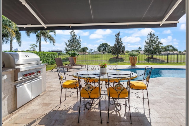 view of patio featuring a fenced in pool, outdoor dining area, area for grilling, a grill, and a fenced backyard