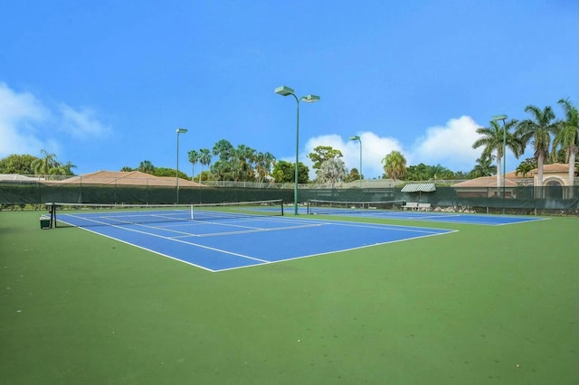 view of sport court featuring fence