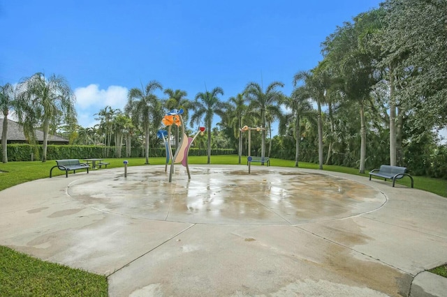 view of community featuring community basketball court and a lawn