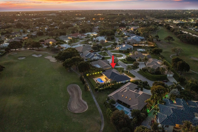 aerial view at dusk featuring a residential view