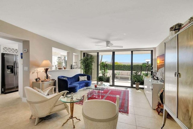 tiled living room with floor to ceiling windows and ceiling fan