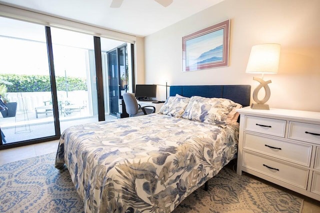 bedroom featuring ceiling fan, expansive windows, and access to exterior