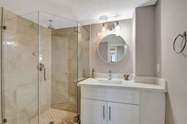 bathroom featuring vanity and a shower with shower door